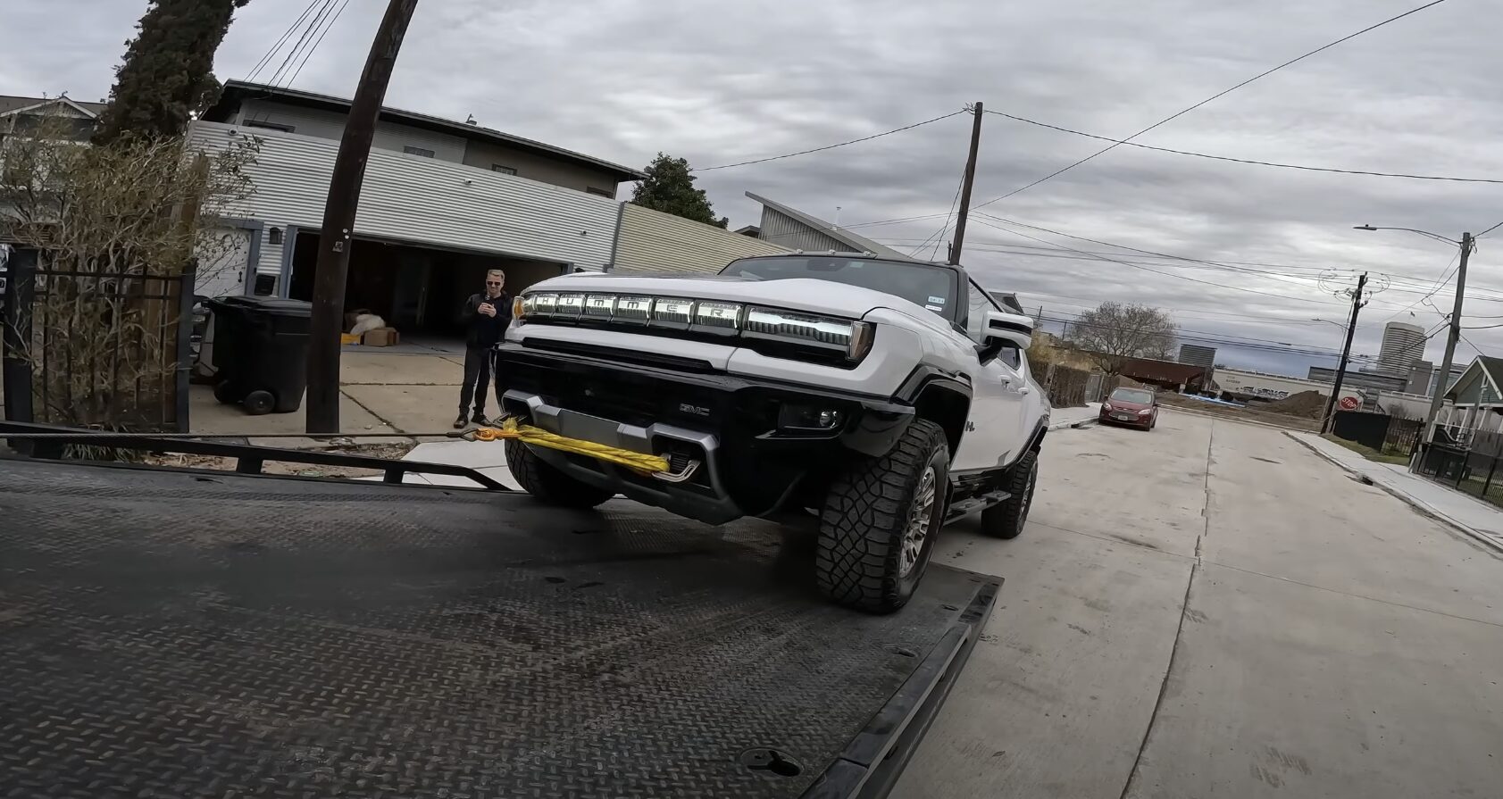 Professional tow truck loading a white pickup truck in Lauderhill, FL