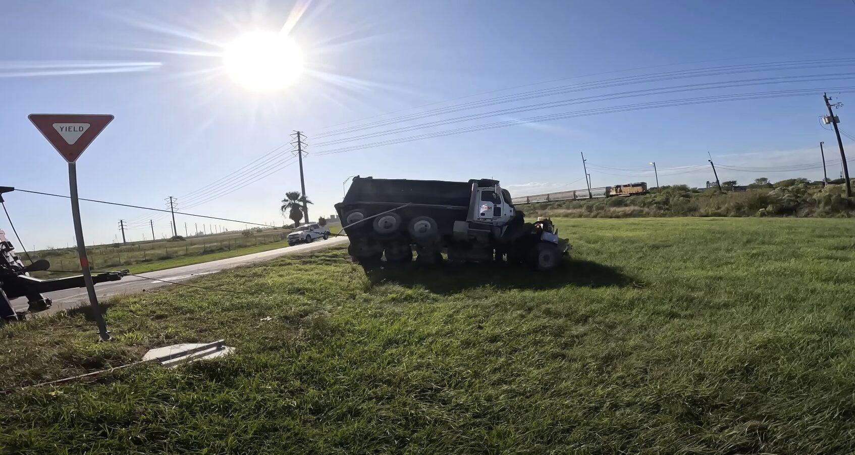 Emergency towing truck recovering an overturned semi-truck