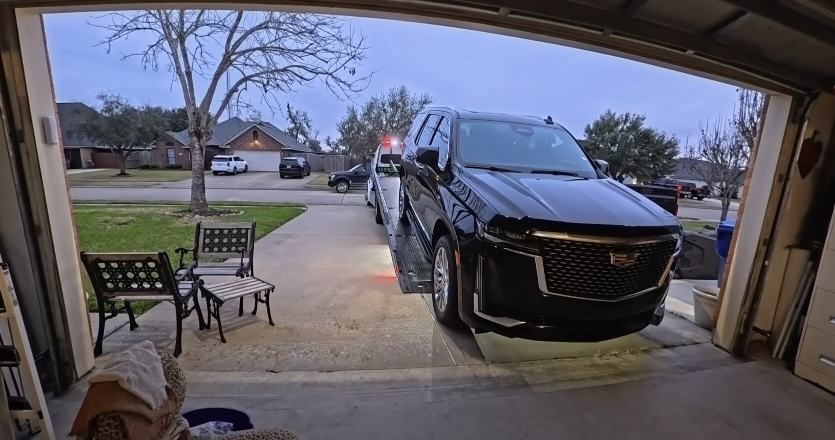 Professional tow truck operator in high-visibility safety gear assisting with vehicle breakdown