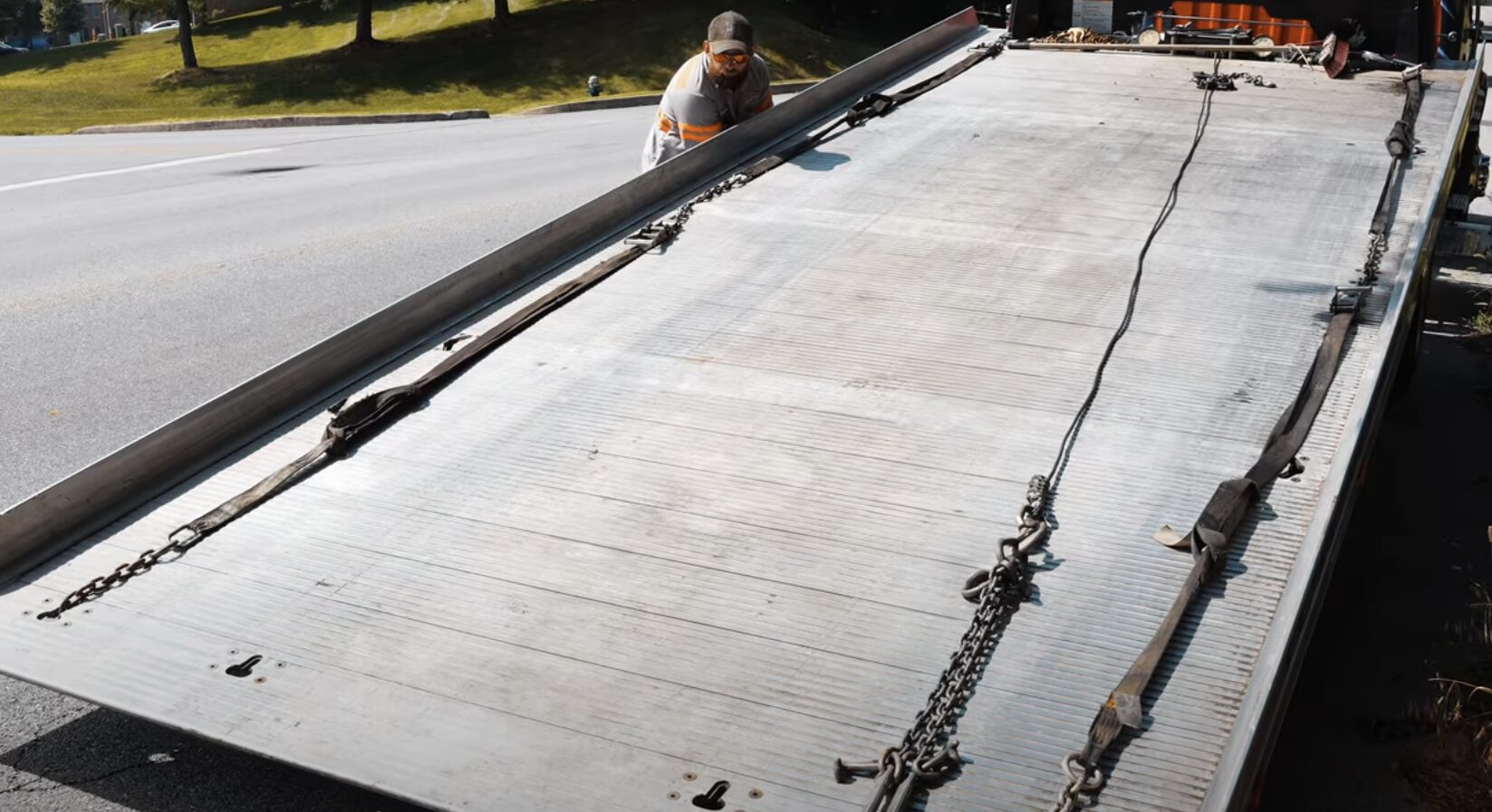 Professional tow truck with flatbed platform ready for vehicle recovery service